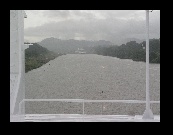 Proceeding down the Culebra Cut, the markers on shore at right center allow the pilot to line up the ship either to the center of the channel or to the right if meeting traffic